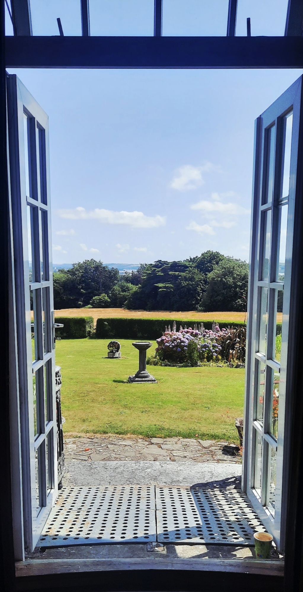 Garden view through open doors at the course venue