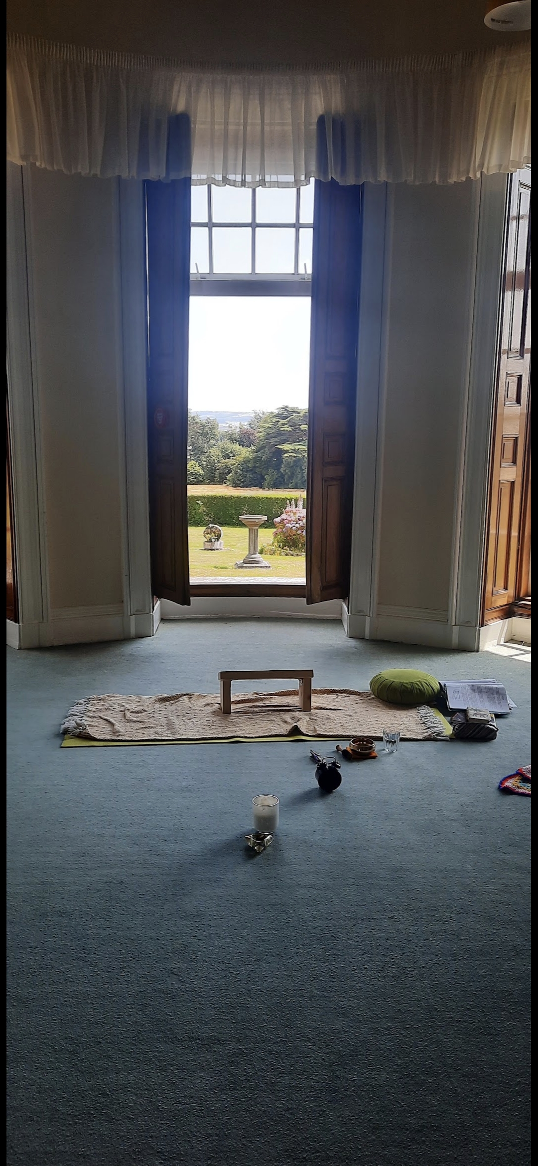 Meditation cushion and bench set up by a window for practice